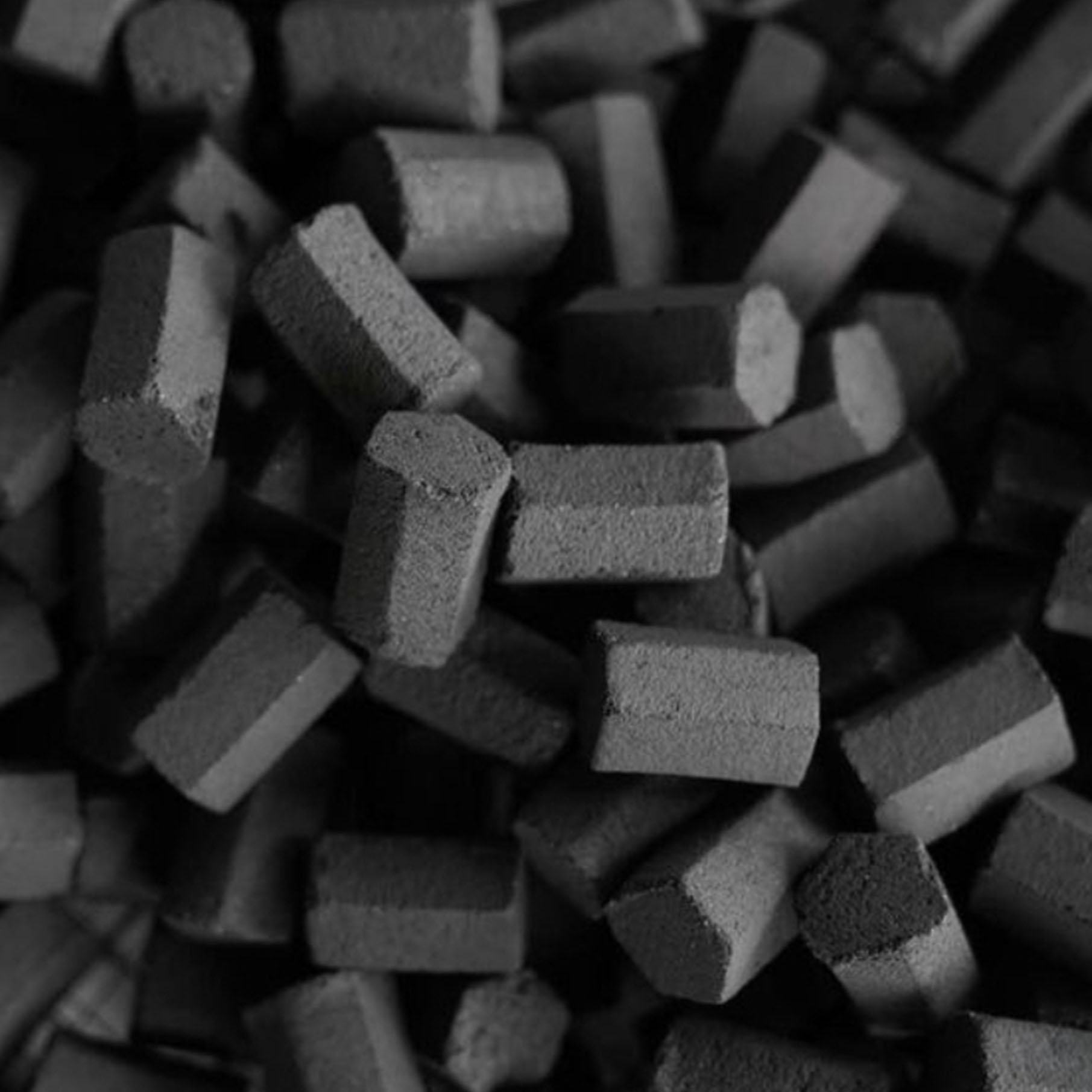 Top view smoldering coals with fire drops in steel flask on dark Top view smoldering coals with fire drops in steel flask on dark background