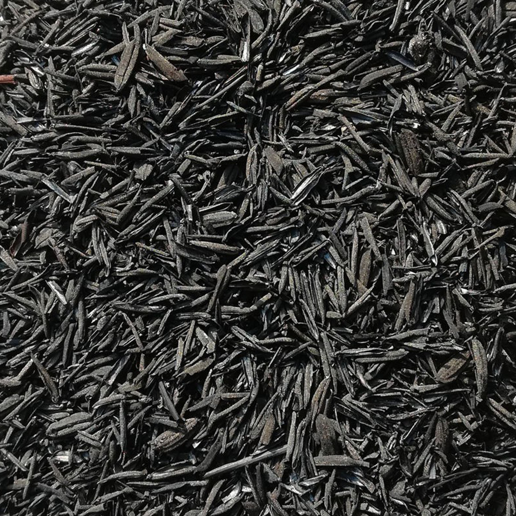 Top view smoldering coals with fire drops in steel flask on dark Top view smoldering coals with fire drops in steel flask on dark background